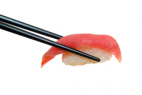 Sushi with chopsticks shot on white